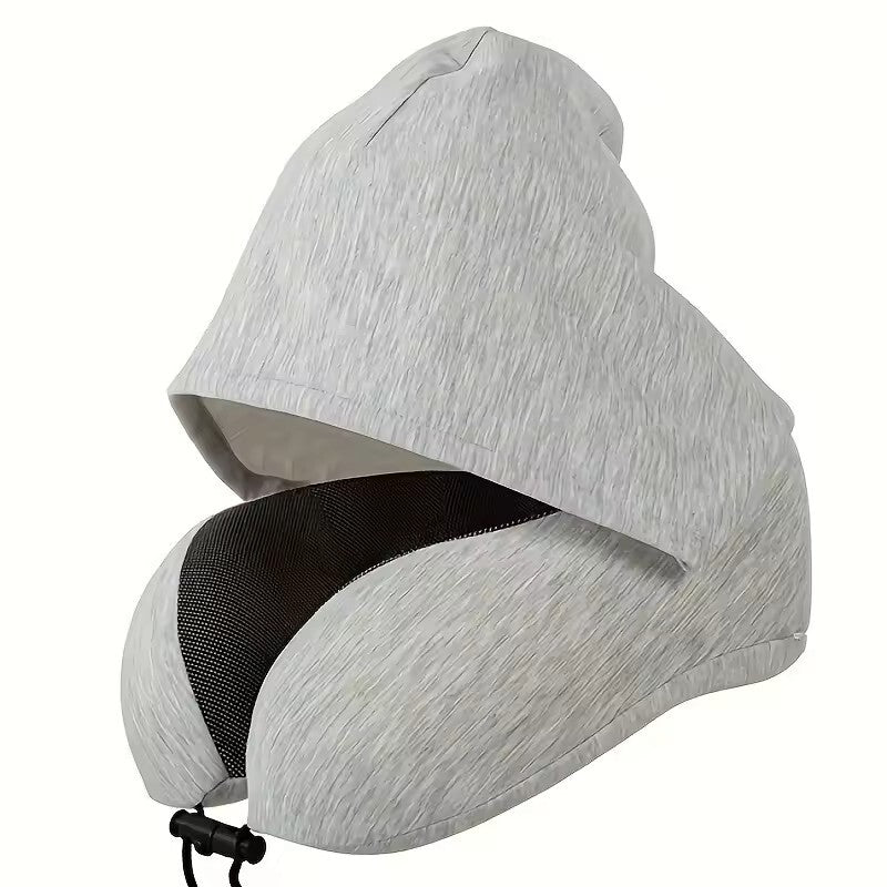 The light heather grey colorway of the Alphinea ergonomic hooded travel pillow, showing the attached blackout sleep mask hood and 360-degree memory foam neck support.