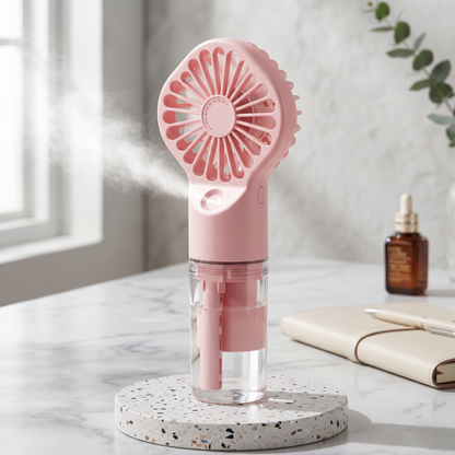 Aesthetic pink Alphinea rechargeable mist fan on a marble surface showing misting functionality.