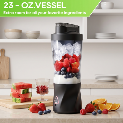 An Alphinea portable blender filled with ice, strawberries, and blueberries on a kitchen counter, emphasizing the large 23-ounce (700ML) vessel that provides extra room for full meal-replacement servings.