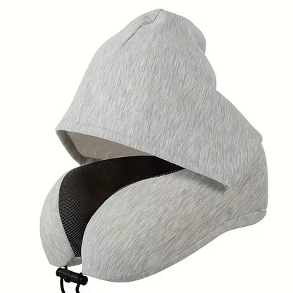 The light heather grey colorway of the Alphinea ergonomic hooded travel pillow, showing the attached blackout sleep mask hood and 360-degree memory foam neck support.