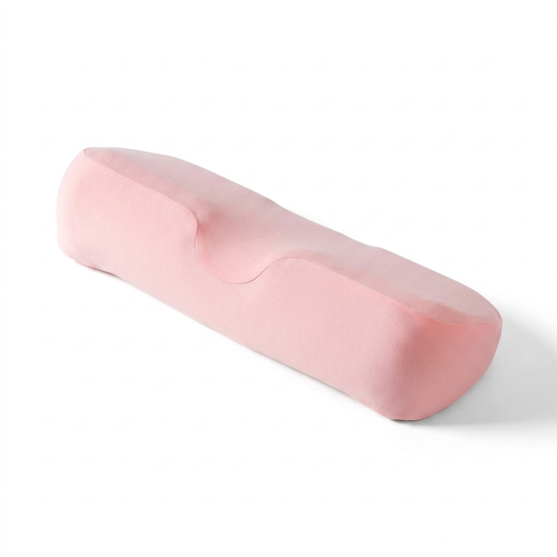 The Alphinea breathable contoured neck pillow in a soft pink color, featuring a washable cover and engineered for deep relaxation and neutral support.