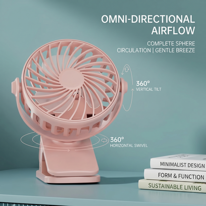 A pink Alphinea portable rechargeable mini clip fan resting on a desk next to minimalist books. Graphic arrows illustrate the 360-degree vertical tilt and 360-degree horizontal swivel for omni-directional airflow.