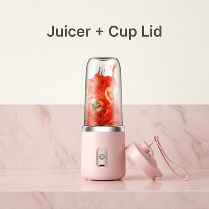 Alphinea Portable USB Personal Blender in pink, featuring a freshly blended red smoothie. The image highlights the high-velocity motor base and the interchangeable premium travel cup lid for liquid mobility.