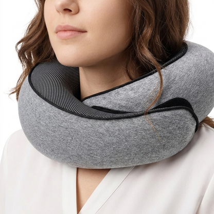 Close-up of a woman wearing the gray Alphinea Snail-Style Memory Foam Pillow, demonstrating its 360-degree wrap-around architecture and snug fit for neck pain relief.