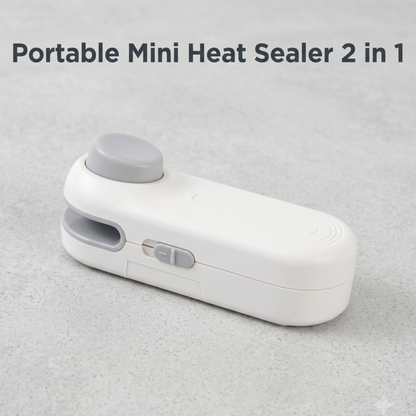 Mini scelleuse thermique portable Alphinea blanche minimaliste 2 en 1, posée sur une surface grise texturée, idéale pour un rangement esthétique dans la cuisine.